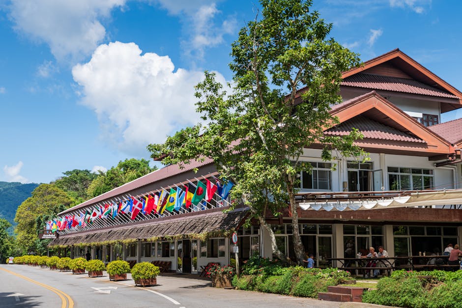 Doi Tung Palace adorned with international flags, nestled in Chiang Rai, Thailand.