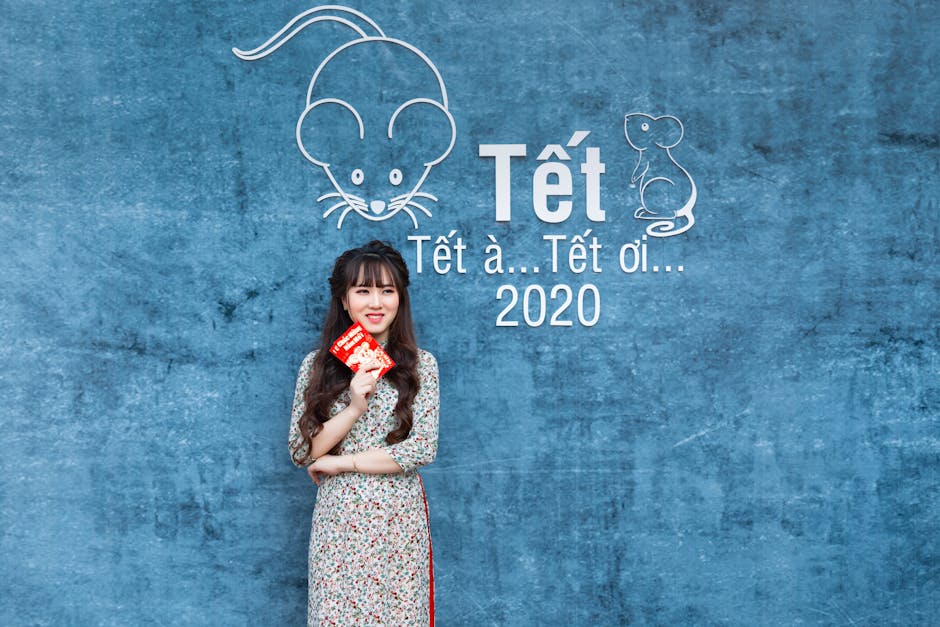 Portrait of a young woman holding red envelopes for Tet 2020, showcasing traditional Vietnamese celebration.