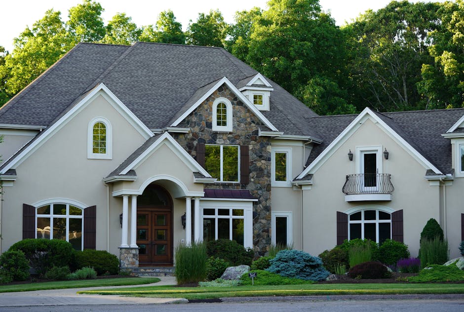 A picturesque view of a large suburban house surrounded by lush greenery.