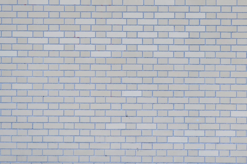 A full-frame image of a seamless white brick wall texture, perfect for backgrounds and architectural designs.