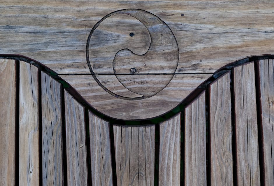 Natural wooden texture featuring a carved yin yang symbol, perfect for design backgrounds.