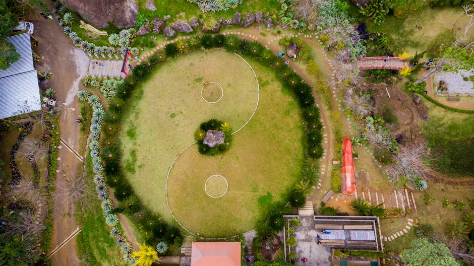 Drone captures a stunning aerial view of a Yin Yang garden design in lush greenery.