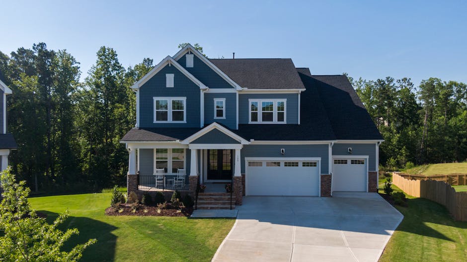 Charming suburban house in Holly Springs, NC, featuring a large driveway and porch.