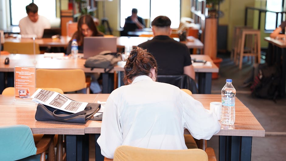 Group of people focused on studying and working at a library in Isparta.