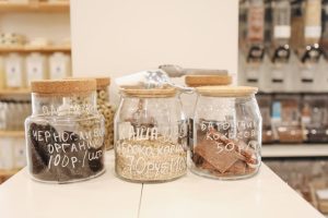 Glass jars with organic snacks on a counter in an eco-friendly zero waste store.