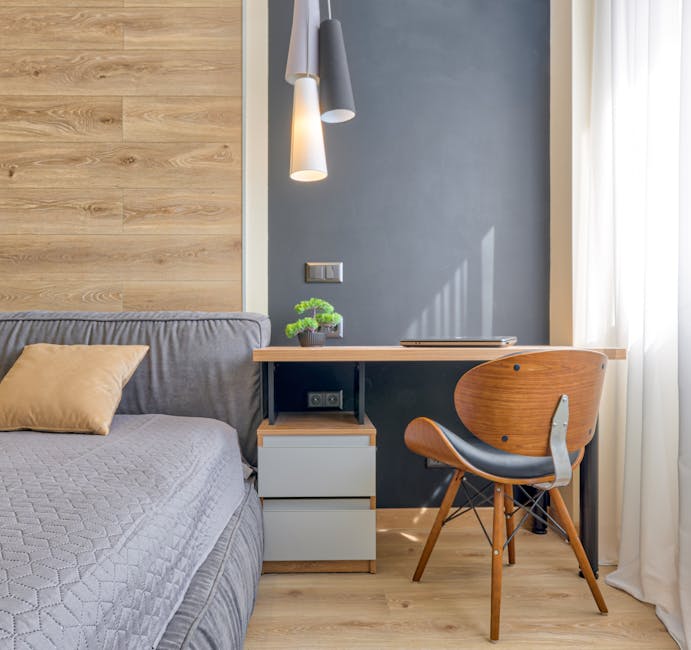 Bright modern bedroom with wooden furniture, gray bed, and soft lighting.